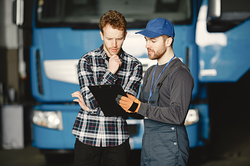 Driver and mechanic reviewing a checklist